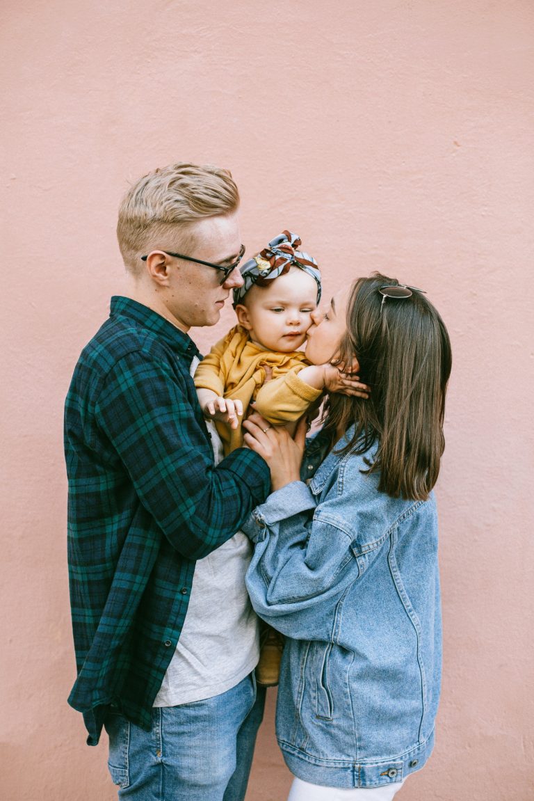 Parent and child looking at a wall calendar together while planning a weekly schedule